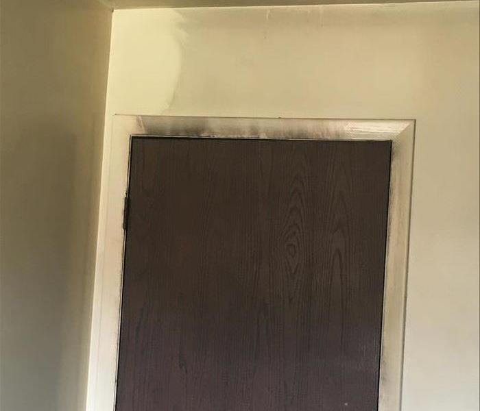 Door frame covered in soot from apartment fire