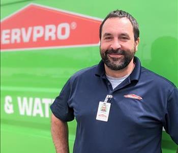 Operations Manager Chad Hobbs next to SERVPRO box truck at Norton Shores location