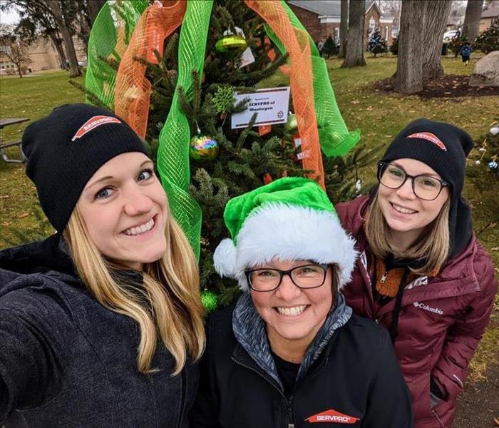 SERVPRO Marketing Ladies standing in front of decorated Christmas tree