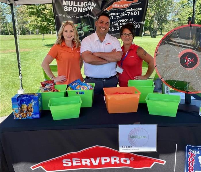 SERVPRO Marketing Team standing at tent during golf outing