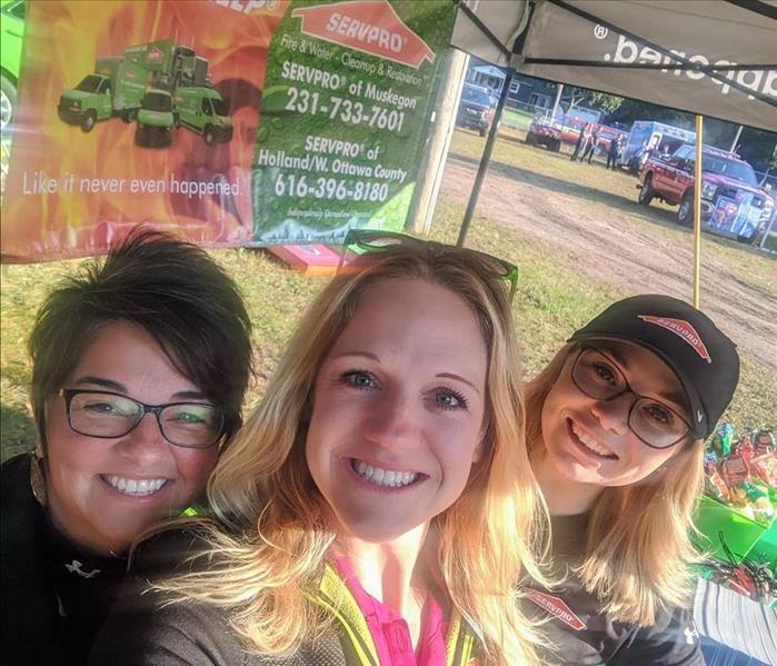SERVPRO Marketing Ladies behind booth at Sportsmen For Youth