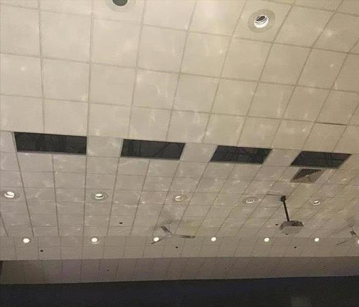 Water reflection on the ceiling of a flooded auditorium.