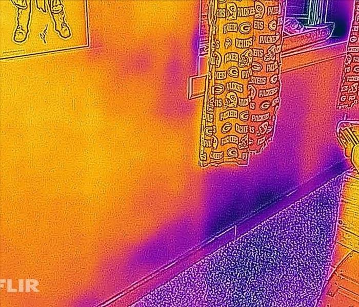 Room with water damage shown through a thermal imaging camera