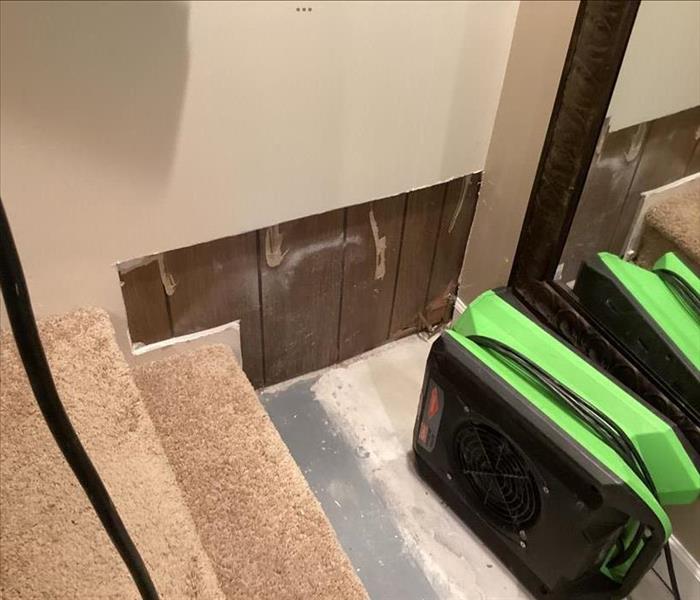 Air mover drying out basement wall